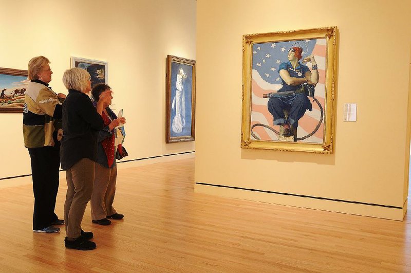 Sara Bainbridge (center), a volunteer guide at Crystal Bridges Museum of American Art, discusses Norman Rockwell’s Rosie the Riveter with Myrtis Wyly (left) and Phoebe Goodwin in January 2013. In the five years since its opening, the Bentonville museum has won over skeptics while drawing big crowds. 