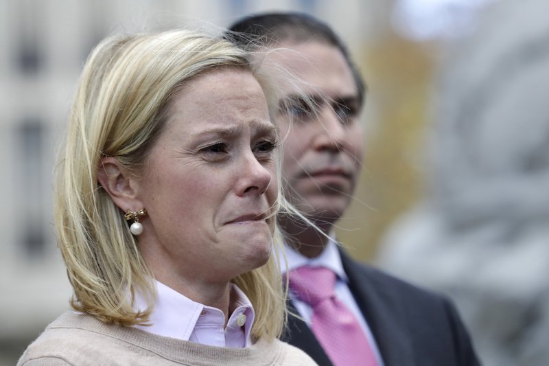 Bridget Anne Kelly, former Deputy Chief of Staff for New Jersey Gov. Chris Christie, listens as her lawyer Michael Critchley talks to reporters after she was found guilty on all counts in the George Washington Bridge traffic trial at Martin Luther King, Jr., Federal Court, Friday, Nov. 4, 2016, in Newark, N.J. 