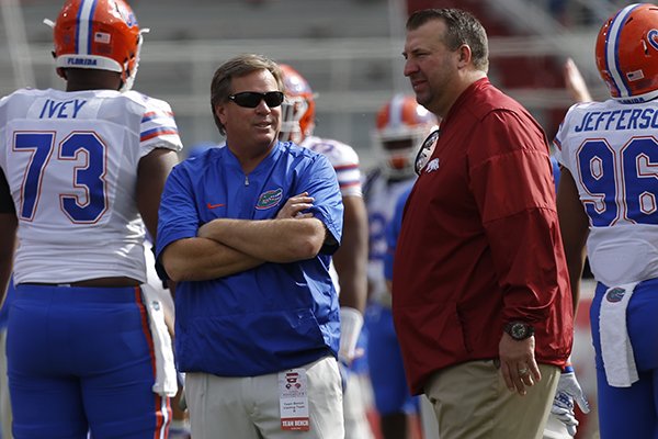 Florida coach Jim McElwain, left, talks with Arkansas coach Bret Bielema prior to a game Saturday, Nov. 5, 2016, in Fayetteville. 