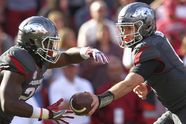 Arkansas Razorbacks quarterback Austin Allen (8) hands off to running back Rawleigh Williams III (22) in the first quarter of the Hogs 31-10 victory over Florida.