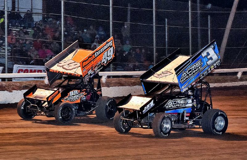 Sammy Swindell of Bartlett, Tenn. (right) passes Tim Shaffer of Aliquippa, Pa., for the lead on the 15th lap during the Short Track Nationals on Saturday at I-30 Speedway in Little Rock. Swindell held on to win the event for the fourth time.