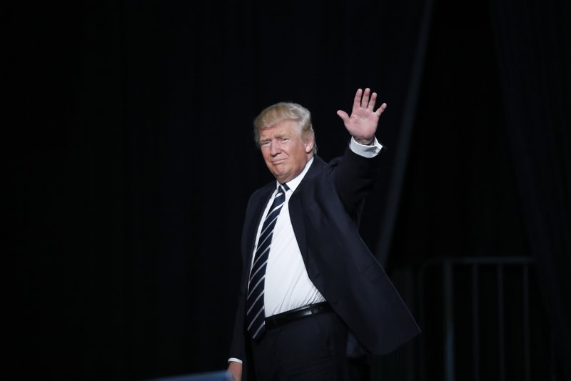 Republican presidential candidate Donald Trump waves to the audience exiting a campaign rally in Grand Rapids, Mich., Tuesday, Nov. 8, 2016. (AP Photo/Paul Sancya)
