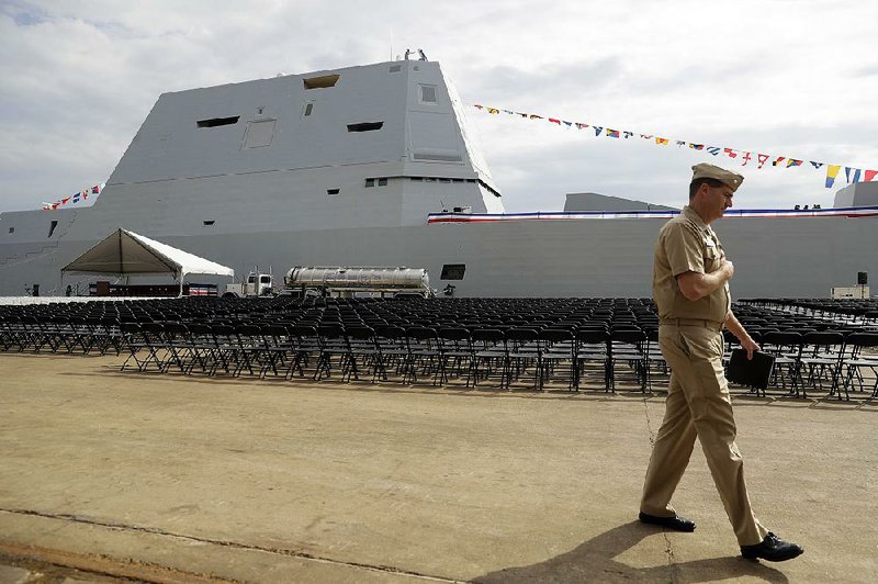 A member of the U.S. Navy passes the USS Zumwalt in October in Baltimore.