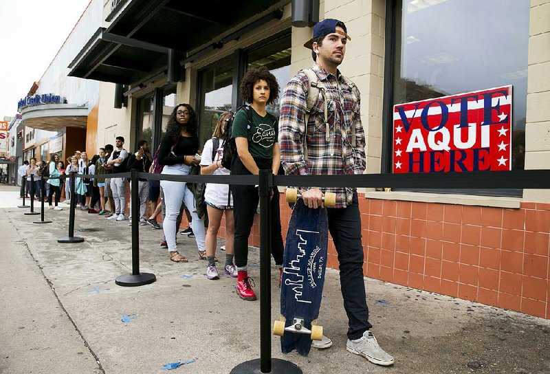 Alton Savoye, a student at the University of Texas at Austin, waits to vote at the polling location Tuesday at the University Co-op.