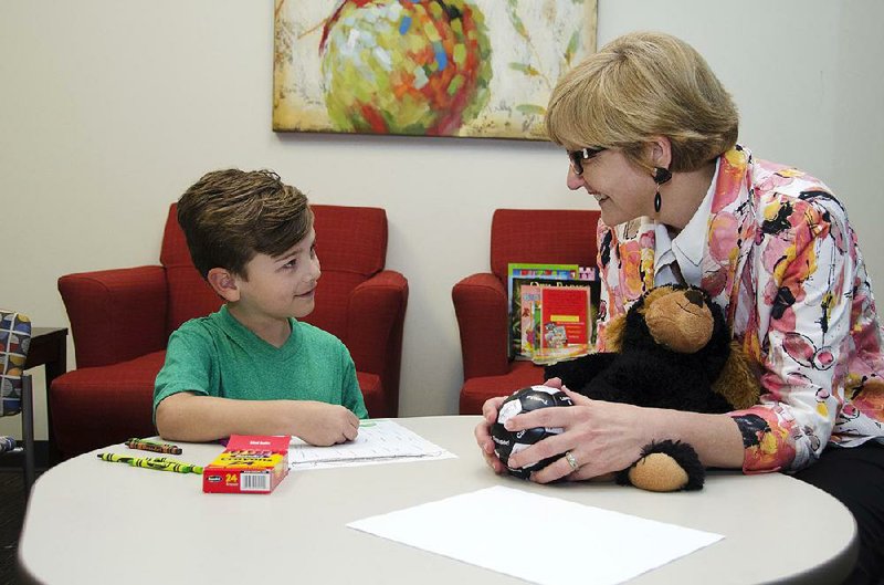 A 7-year-old boy meets with Lynna Hollis, a child and adolescent psychiatrist, at the Nashville, Tenn., location of Centerstone, a community mental health provider. 