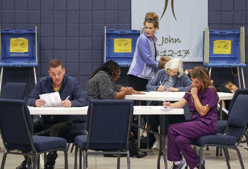 Voters cast ballots at First United Methodist Church in Maumelle on election day Tuesday.