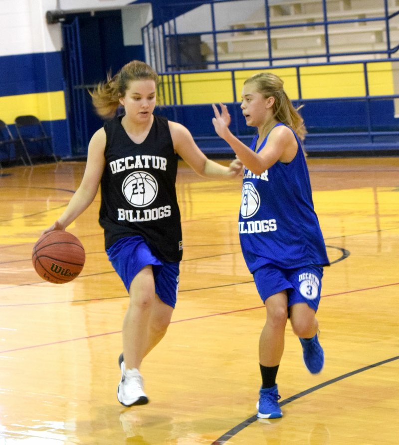 Photo by Mike Eckels Abby Tilley (left) drives down court against Destiny Majia during a joint junior-senior high school girls&#8217; basketball practice at Peterson Gym in Decatur Oct 25. The Decatur High School basketball season starts at home Nov. 11.