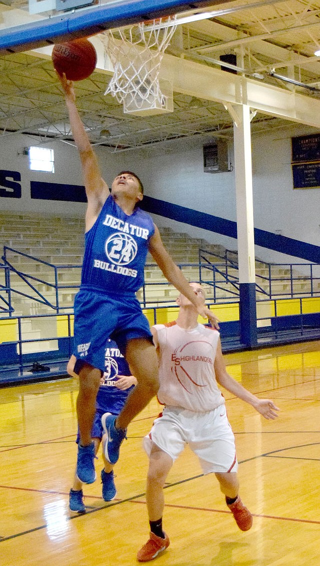 Photo by Mike Eckels Decatur&#8217;s Marck Guadarrama (24) goes for a lay up against a Highlander player during the second game of the Decatur Summer Classic at Peterson Gym in Decatur June 14. Guadarrama is one of six seniors that are returning for their final season with the Bulldogs.