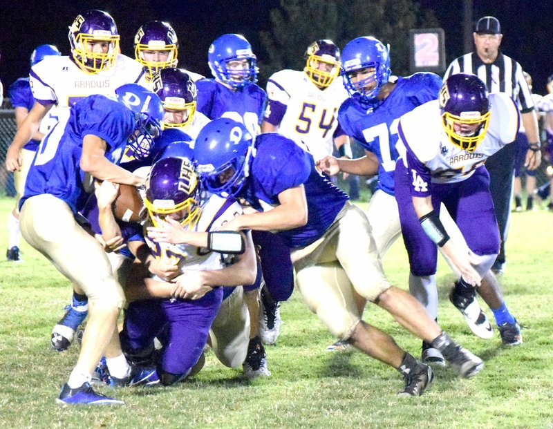 Photo by Mike Eckels Bulldogs&#8217; defensive back Gary Woods (foreground, left) strips the ball away form a Golden Arrow running back during the Nov. 4 Decatur-Lavaca game at Bulldog Stadium in Decatur. Woods efforts set up the only Decatur score.