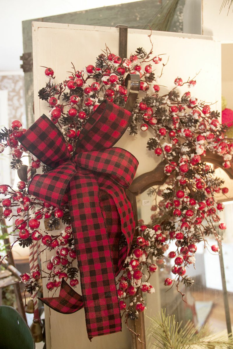 Buffalo check &#x2014; red and black plaid &#x2014; is popular this year for Christmas decorations. Pictured is one of the many creative holiday wreaths at The Back Porch.