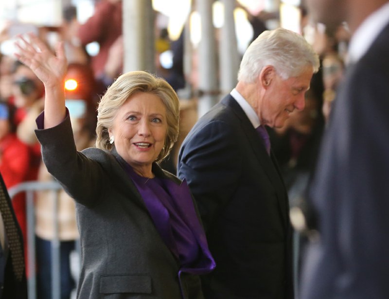 Hillary Clinton, holding hands with her husband, former President Bill Clinton, waves to a crowd outside a New York hotel as she arrives to speak to her staff and supporters after losing the race for the White House, Wednesday, Nov. 9, 2016. Earlier in the day she conceded the race to Republican president-elect Donald Trump.