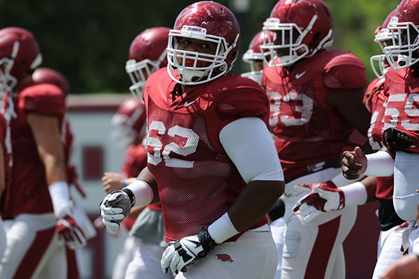 Arkansas offensive lineman Johnny Gibson (62) runs Tuesday, Aug. 11, 2015, during practice at the university's practice field in Fayetteville.
