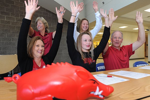 Rogers golfer Brooke Matthews (center) is joined by her mother, Gwen Mathews (clockwise from left); coach Brenda Alexander; sister, Brittany Matthews, 15; and father, Terry Matthews, as they call the Hogs Wednesday, Nov. 9, 2016, after Brooke Matthews signed a letter of intent to play golf for Arkansas during a signing ceremony at the school.