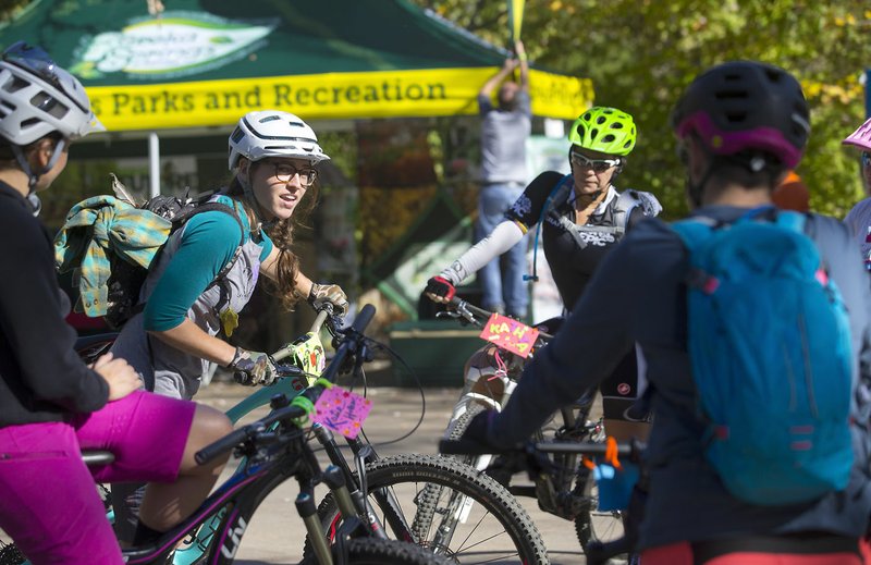Tandie Bailey of Bentonville and others gather Wednesday before heading out on the Women’s Skills Clinic on as part of the International Mountain Bicycling Association’s World Summit Expo at Compton Gardens in Bentonville.
