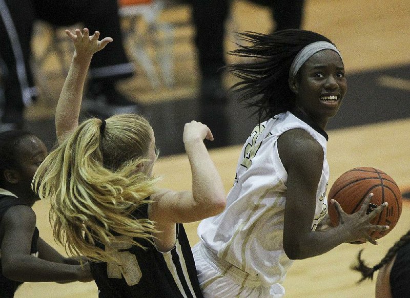 Little Rock Central forward Erynn Barnum looks for an open teammate while Joe T. Robinson guard Mckenzie Fredrick defends during Thursday’s game in the Ladies HardWood Jam Showcase. Central cruised to a 73-14 victory.