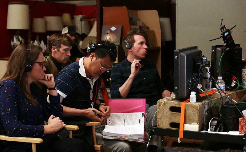 Jayme Lemons, (from left) Graham Gordy, Peter Chan and director Daniel Campbell work Thursday during the filming of the movie Antiquities in North Little Rock.