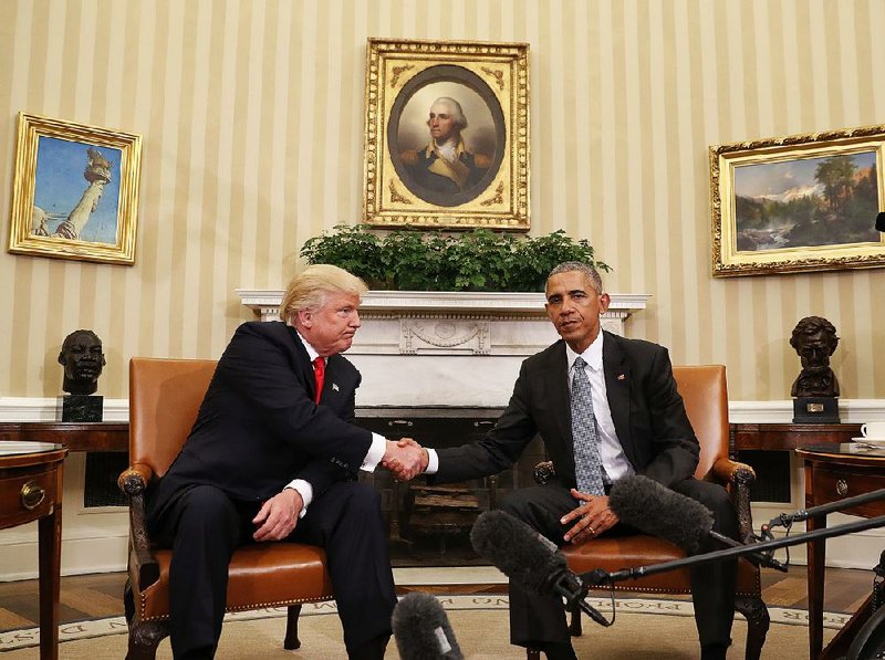 President-elect Donald Trump and President Barack Obama pose for pictures Thursday in the Oval Office after their private meeting. They did not “re-litigate their differences,” White House spokesman Josh Earnest said. “We’re on to the next phase.” 