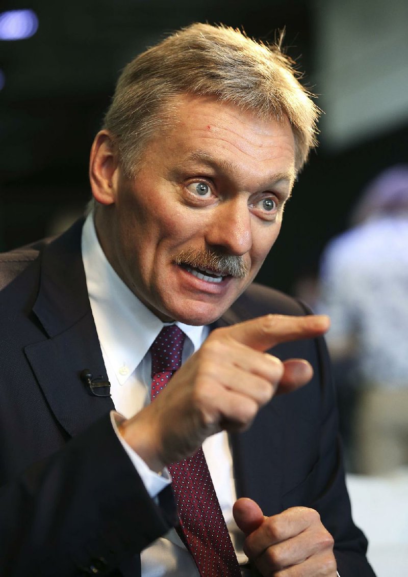Kremlin press secretary Dmitry Peskov talks to a reporter in New York, Thursday, Nov. 10, 2016. In careful phrasing befitting the spy he once was, Peskov,  top Russian diplomat and Vladimir Putin's spokesman said Thursday that Russian experts were in contact with some members of President-elect Donald Trump's staff during the presidential campaign, a period in which the United States accused Russia of hacking into Democratic Party emails systems. A spokeswoman for Trump denied the assertion. 