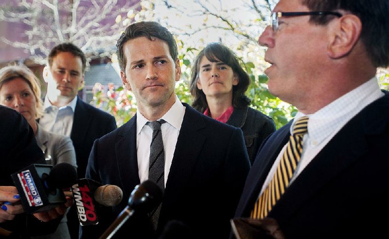Former U.S. Rep. Aaron Schock (center) is surrounded by family members at a news conference Thursday in Peoria Heights, Ill., where defense attorney Jeff Lang (right) spoke about the case against him. 