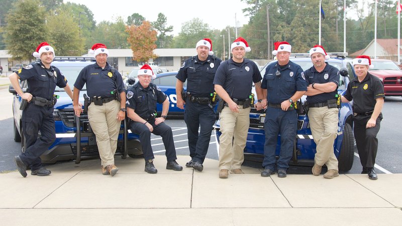 From left, Lt. Shawn Fullington; Sgt. Lee Prickett; Cpl. Mike Montgomery; Officers Chad Winkler, Adam Vanveelen, Michael Turner and Robert Alpe; and Sgt. Todd Crowson of the Bryant Police Department show their support for No Shave November in an effort to raise money for Santas with Badges, a program that helps give children in need a better Christmas.