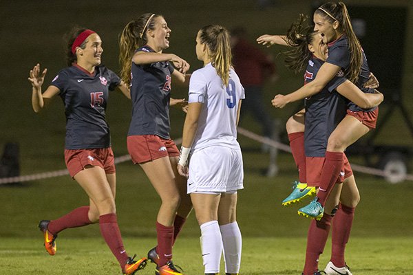 Arkansas' Jessi Hartzler (from left), Kayla McKeon, Lindsey Mayo and Cailee Dennis celebrate as Memphis' Valerie Sanderson (near) watches on Friday, Nov. 11, 2016, after Mayo's game-winning goal in their NCAA tournament first round game at Razorback Field in Fayetteville.