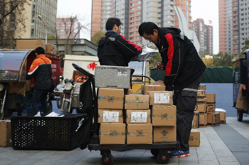 Delivery workers sort parcels Friday in Beijing as shoppers flocked to online retailers for deals on the day known in China as Singles Day.