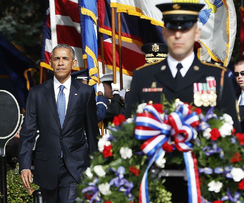 President Barack Obama arrives to lay a wreath at the Tomb of the Unknowns in a Veterans Day ceremony Friday at Arlington National Cemetery in Arlington, Va.