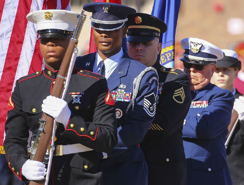 A color guard made up of multiple branches of the military presents the flag Friday at the opening of the Veterans Day ceremony on grounds of the new state Veterans Home in North Little Rock. The $24 million facility was unveiled to the public as part of the event.