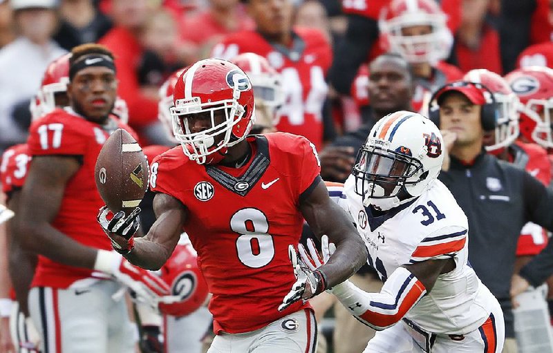 Georgia wide receiver Riley Ridley (8) makes a catch Saturday in front of Auburn defensive back Javaris Davis (31) during the Bulldogs’ 13-7 victory over the No. 9 Tigers in Athens, Ga. 