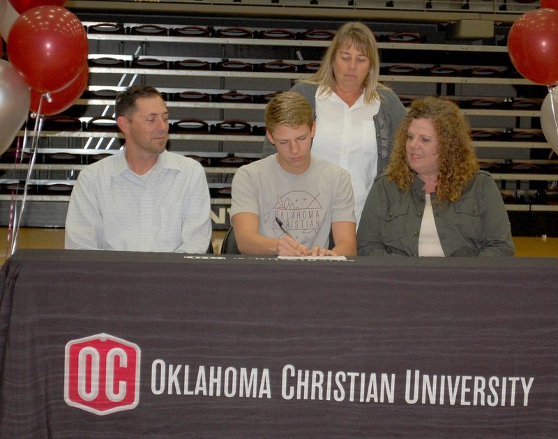 Graham Thomas/Siloam Sunday Siloam Springs senior Brittan Butler, middle, signed a letter of intent Wednesday to swim at Oklahoma Christian University. Also pictured with Butler are his father David Butler, left, mother Shereea Butler, right, and Siloam Springs swimming coach Stephanie Goddard, back.