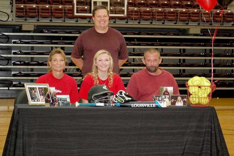 Graham Thomas/Siloam Sunday Siloam Springs senior Crissa Spry signed a letter of intent Wednesday to play softball at Coffeyville (Kan.) Community College. Pictured with Spry, middle, is her mother Tami Wagers, left, father Kenny Spry, right, and Siloam Springs head coach Scott Wright, back.