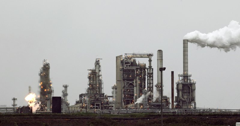 This April 2, 2010 file photo shows a Tesoro Corp. refinery, including a gas flare flame that is part of normal plant operations, in Anacortes, Wash. 