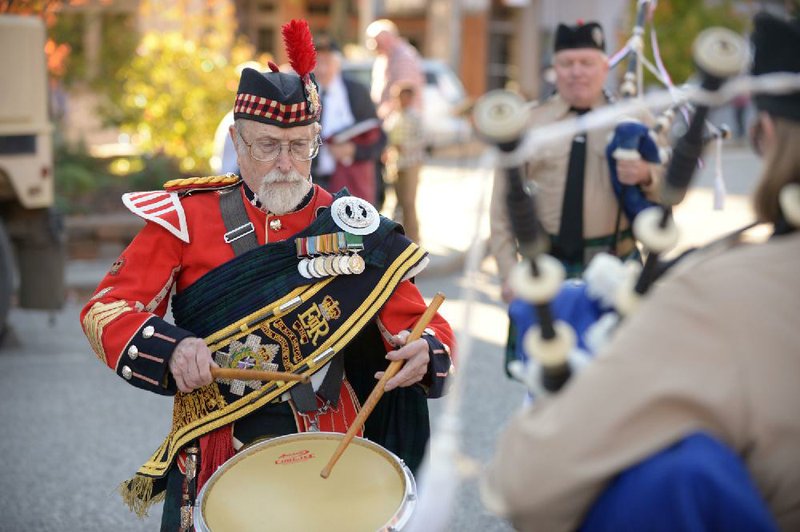 Ramon Hendricks, a founding member of the Ozark Highlanders Pipe Band and a Korean War veteran, plays a snare drum solo on Sunday after the band marched in the annual Veterans Day parade on the Fayetteville square.