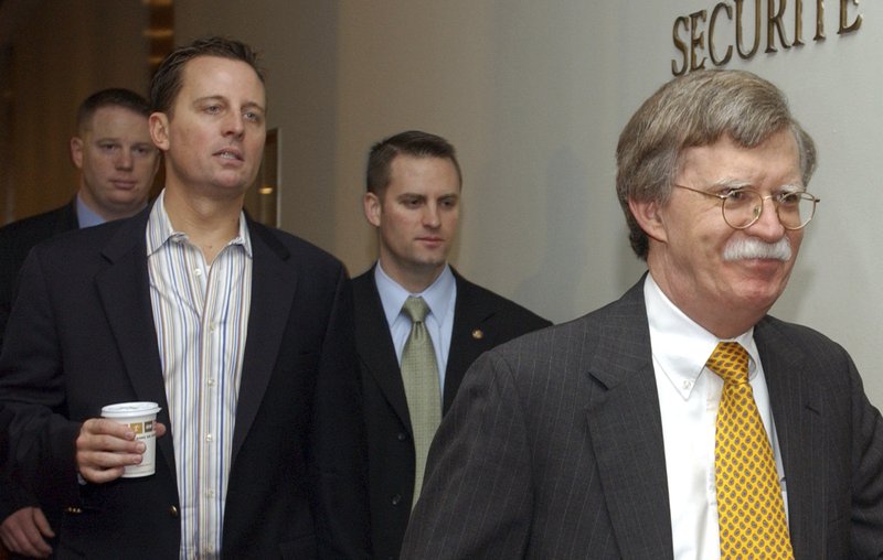 In this Nov. 11, 2006 file photo, Richard Grenell, left, walks with John Bolton, the United States ambassador to the United Nations, right, to a Security Council meeting on an Arab-backed draft resolution condemning the Israeli military offensive in Gaza at the United Nations headquarters in New York.