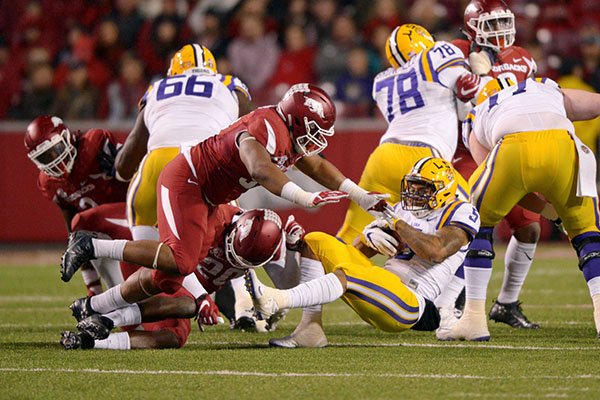 Arkansas safety De'Andre Coley (20) is injured after hitting LSU running back Derrius Guice during a game Saturday, Nov. 12, 2016, in Fayetteville. 