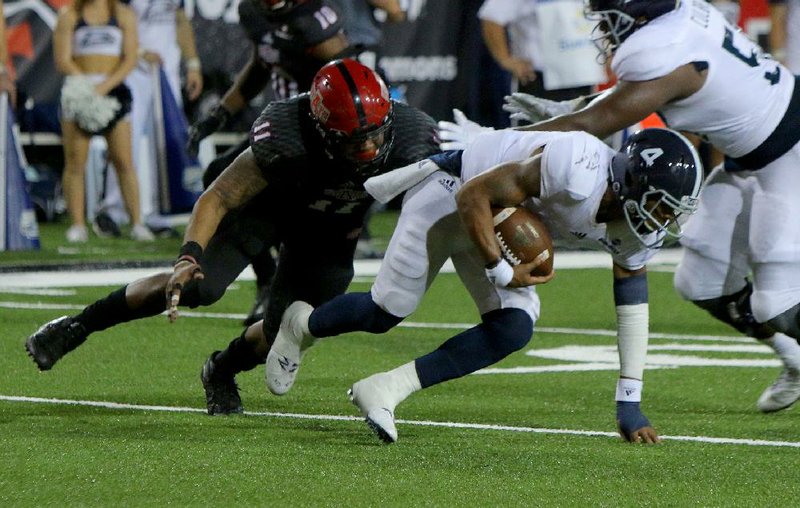 Arkansas State defensive end Ja’Von Rolland-Jones tackles Georgia Southern quarterback Kevin Ellison in the Red Wolves’ 27-26 victory Oct. 5. Rolland-Jones had three sacks in Saturday’s victory over New Mexico State and is closing in on career records for both Arkansas State and the Sun Belt Conference.