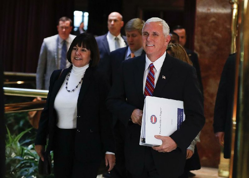 Vice President-elect Mike Pence arrives Tuesday at Trump Tower in New York with his wife, Karen, to continue work with President-elect Donald Trump to fill key administration posts.