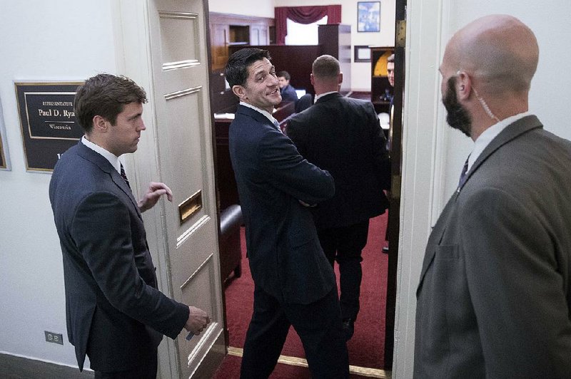 House Speaker Paul Ryan walks into his office Tuesday after a news conference on Capitol Hill in Washington.