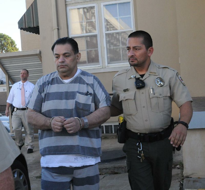 A Benton County sheriff’s deputy escorts Mauricio Torres out of court Tuesday after he was sentenced to death by lethal injection in the death of his 6-year-old son.