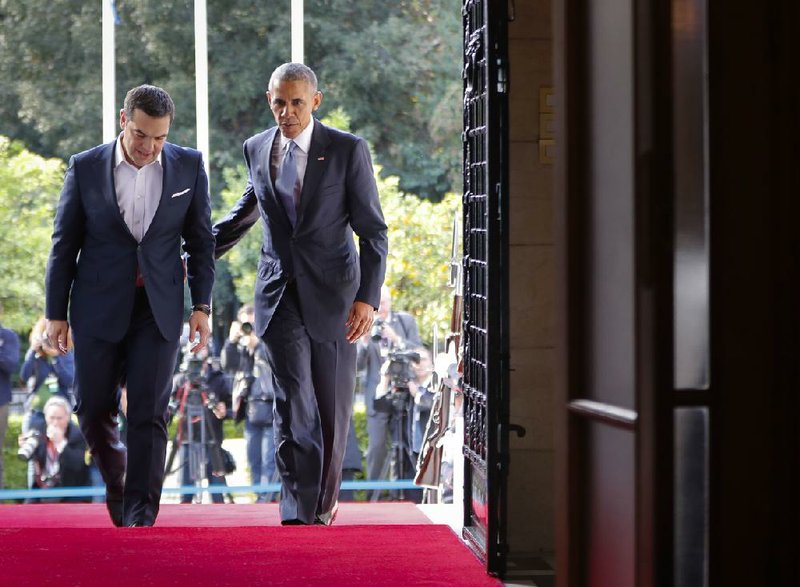 Greek Prime Minister Alexis Tsipras (left) and President Barack Obama enter the Maximos Mansion in Athens on Tuesday for talks and a news conference. “In the United States, we know what happens when we start dividing ourselves along lines of race or religion or ethnicity. It’s dangerous,” Obama said at the news conference, appearing to reverse his conciliatory stand about a Donald Trump presidency.