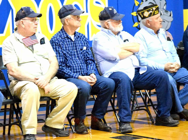 Photo by Mike Eckels A group of military veterans from the Howard-Parrish Veterans of Foreign Wars Post 9834 in Decatur watch a video presentation during the second annual Decatur High School Veterans Day Assembly at Peterson Gym in Decatur Nov. 11.