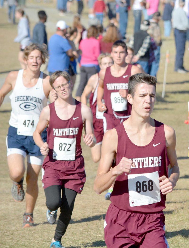 Graham Thomas/Herald-Leader Junior Isaac Leachman, followed by seniors Parker Wallis and Charlie Jones run at the start of the Class 6A Boys Meet on Saturday at Oaklawn Park in Hot Springs. Siloam Springs finished third overall behind state champion Lake Hamilton and Greenwood.