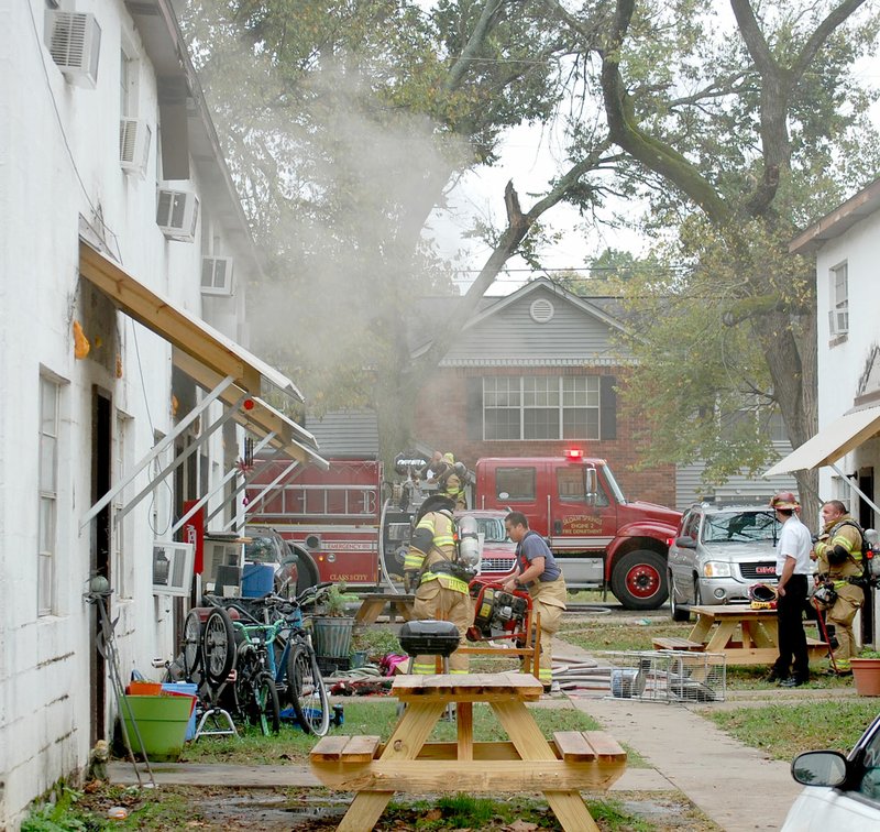 Michael Burchfiel/Herald-Leader Siloam Springs firefighters responded to a call on Nov. 8 for a fire on West Tahlequah Street. The fire was contained to one apartment unit and no one was hurt, according to the incident report. Adjoining units were ventilated to reduce carbon monoxide levels.