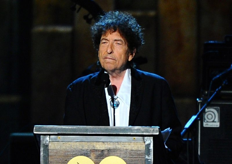 FILE - In this Feb. 6, 2015 file photo, Bob Dylan accepts the 2015 MusiCares Person of the Year award at the 2015 MusiCares Person of the Year show in Los Angeles. The Swedish Academy says Dylan is not coming to Stockholm to pick up his 2016 Nobel Prize for literature at the Dec. 10, 2016 prize ceremony. (Photo by Vince Bucci/Invision/AP, File)
