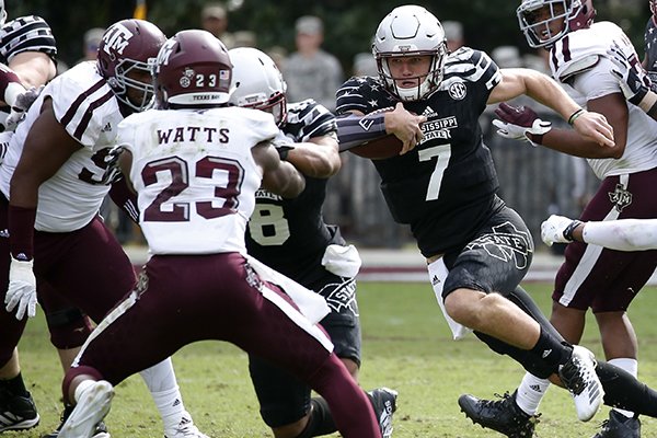 Mississippi State quarterback Nick Fitzgerald (7) runs at Texas A&M defensive back Armani Watts (23) and other defenders during their NCAA college football game in Starkville, Miss., Saturday, Nov. 5, 2016. Mississippi State won 35-28. (AP Photo/Rogelio V. Solis)

