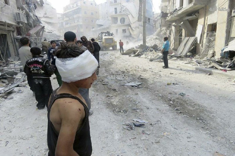 An injured child walks Wednesday in a destroyed street of Aleppo, Syria. Government airstrikes damaged several areas of the city, including a children’s hospital.