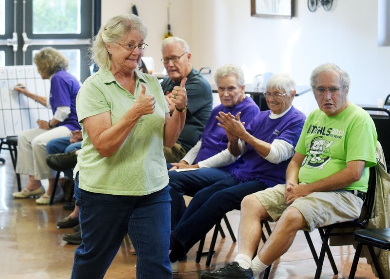 Ruth Smith of Elkins gives herself a “thumbs up” after scoring a home run Oct. 27 during a bean bag baseball
game at the Elkins Senior Center Activity Center. The program sponsored by the regional office of the Area
Agency on Aging in Harrison is designed to keep seniors active and social.