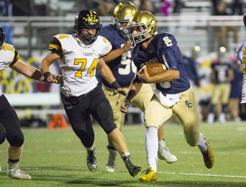 Shiloh Christian’s Connor Reece (3) looks for running room against Prairie Grove’s defense Oct. 7 at Champion Stadium in Springdale.