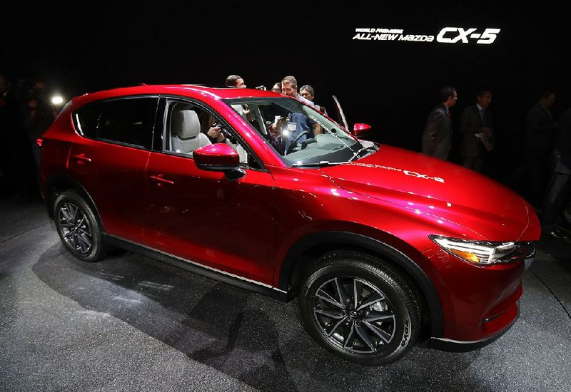 A 2017 Mazda CX-5 is displayed Wednesday at the Los Angeles Auto Show. The new midsize SUV goes on sale in Japan in February and the U.S. after that.