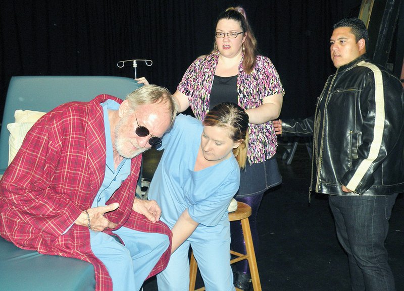 The nurse, played by Rachel Loveless, assists Peter Ravenswaal, played by Len Schlientz, in this rehearsal scene of Wrong Turn at Lungfish. Also shown are Anita Merendino, played by Erin Henderson, and Dominic de Ceasar, played by Miguel Castillo. The show will open Dec. 2 at The Lantern Theatre in Conway.